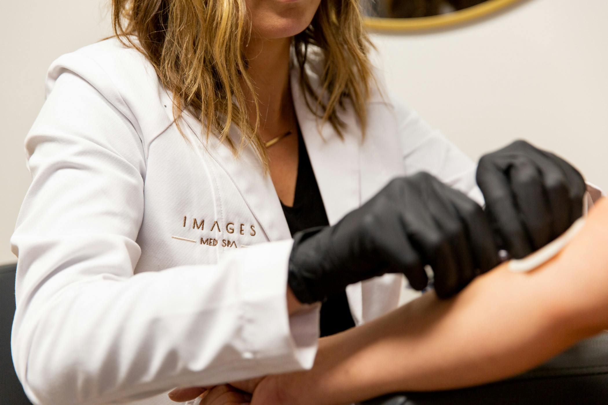staff wearing an images medspa coat