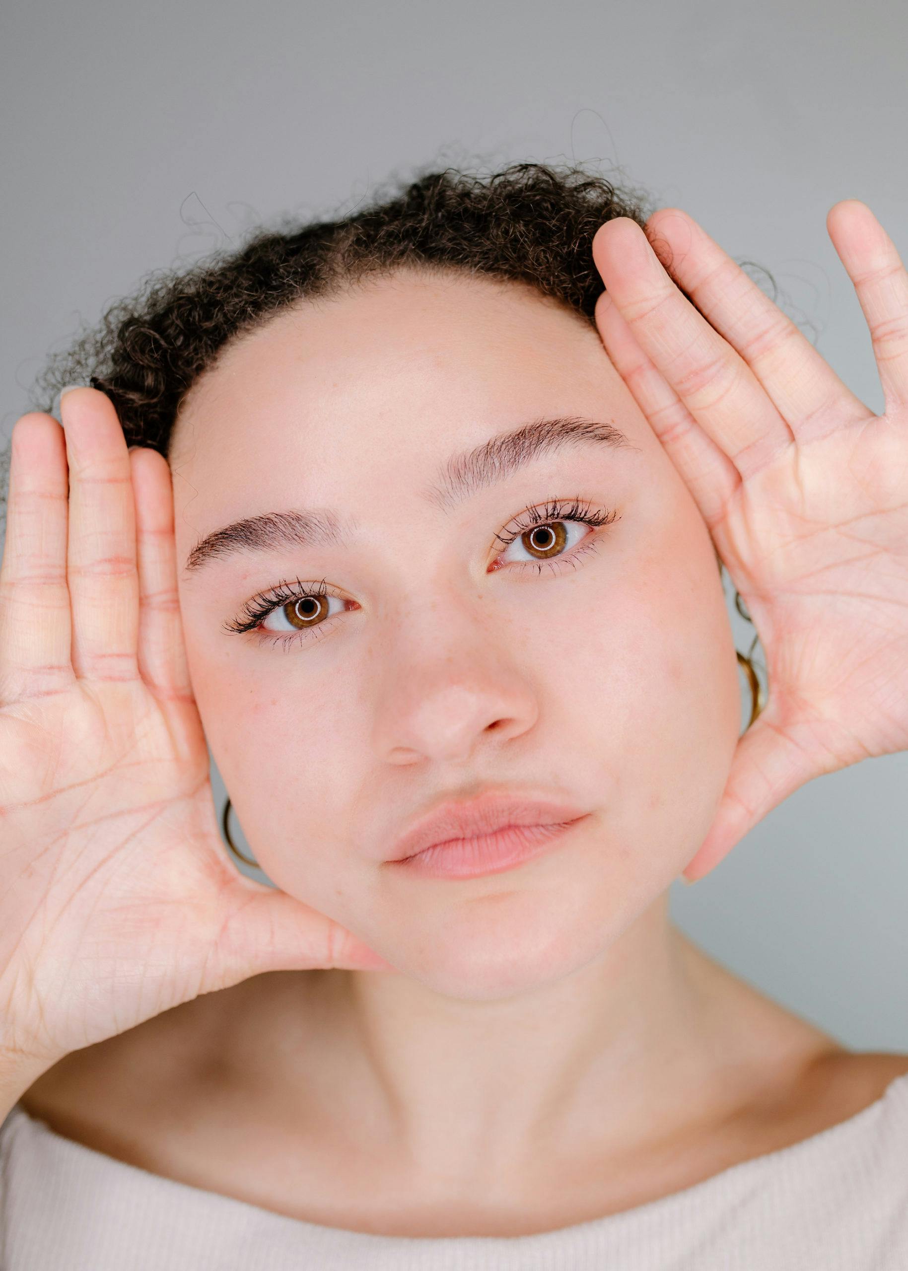 woman with her hands framing her face