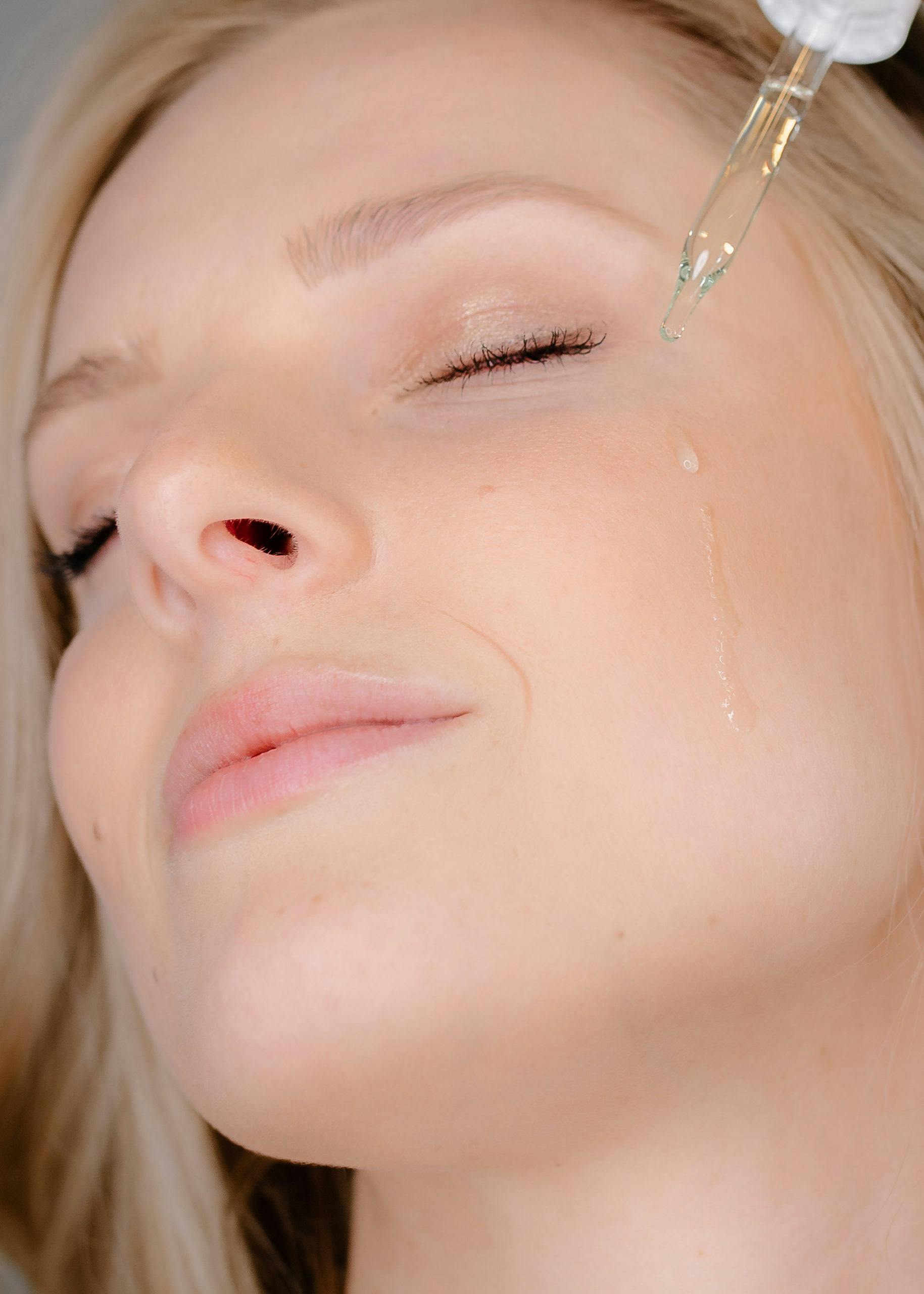 woman with face serum 