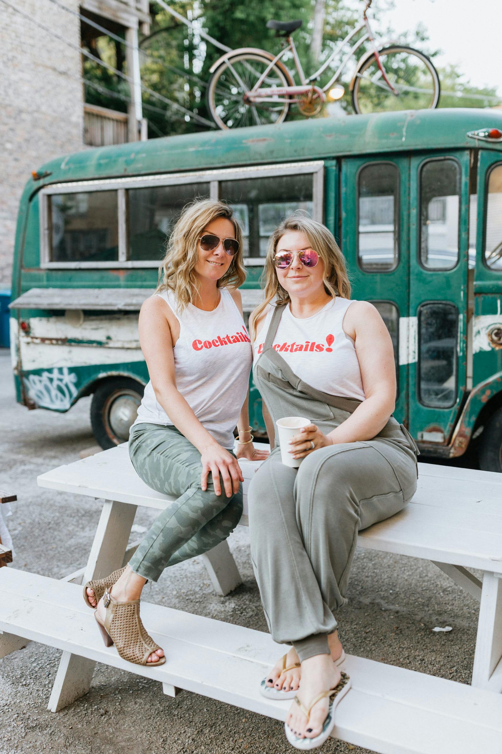 two women wearing shirts that say cocktails