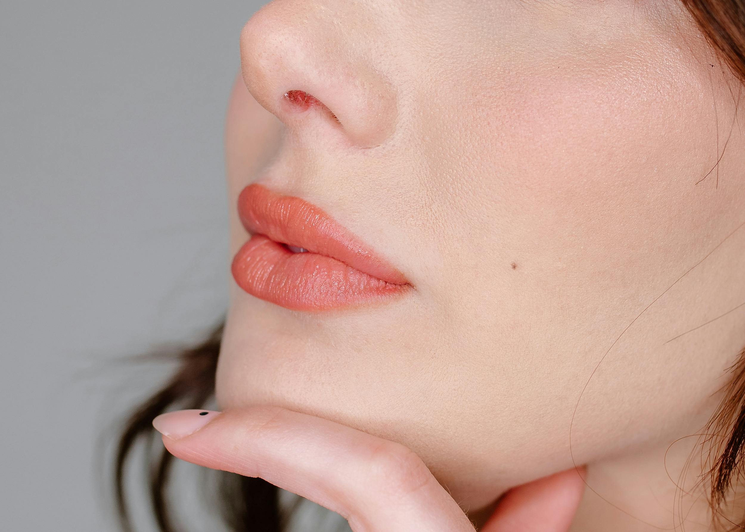 woman wearing pink lipstick