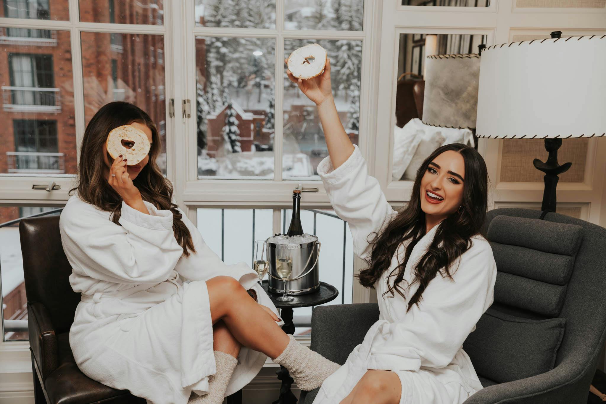 two women eating bagels