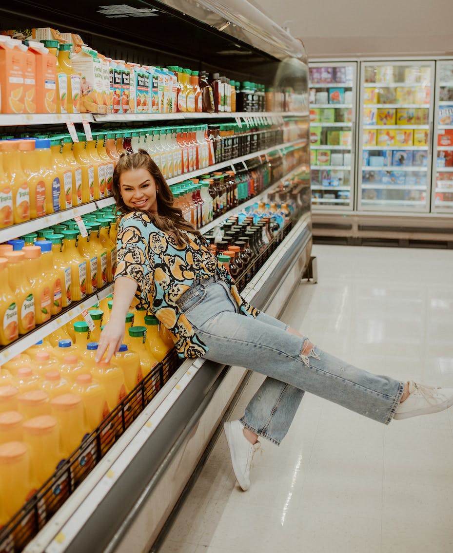 woman posing near orange juice