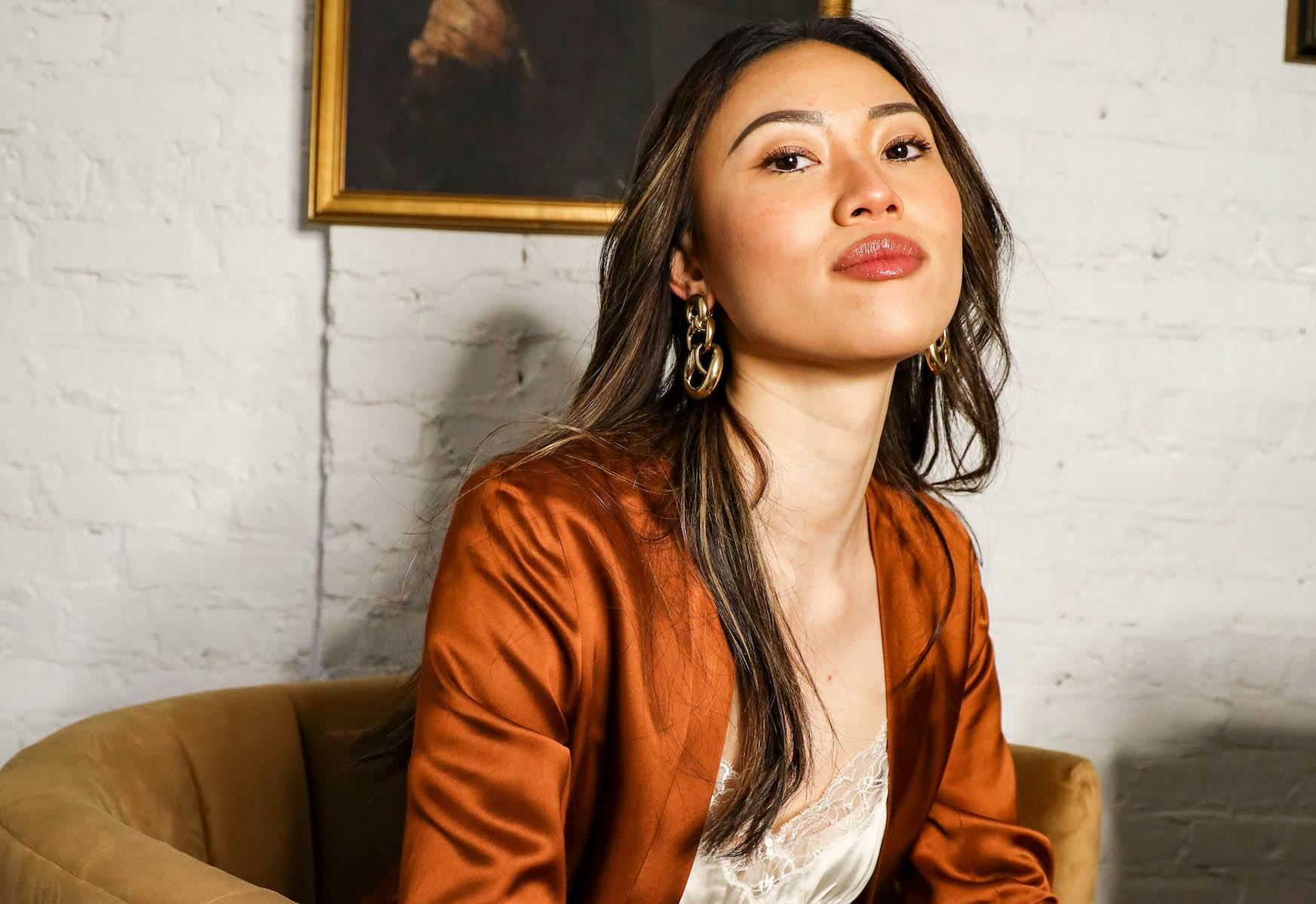 woman wearing a copper silk top