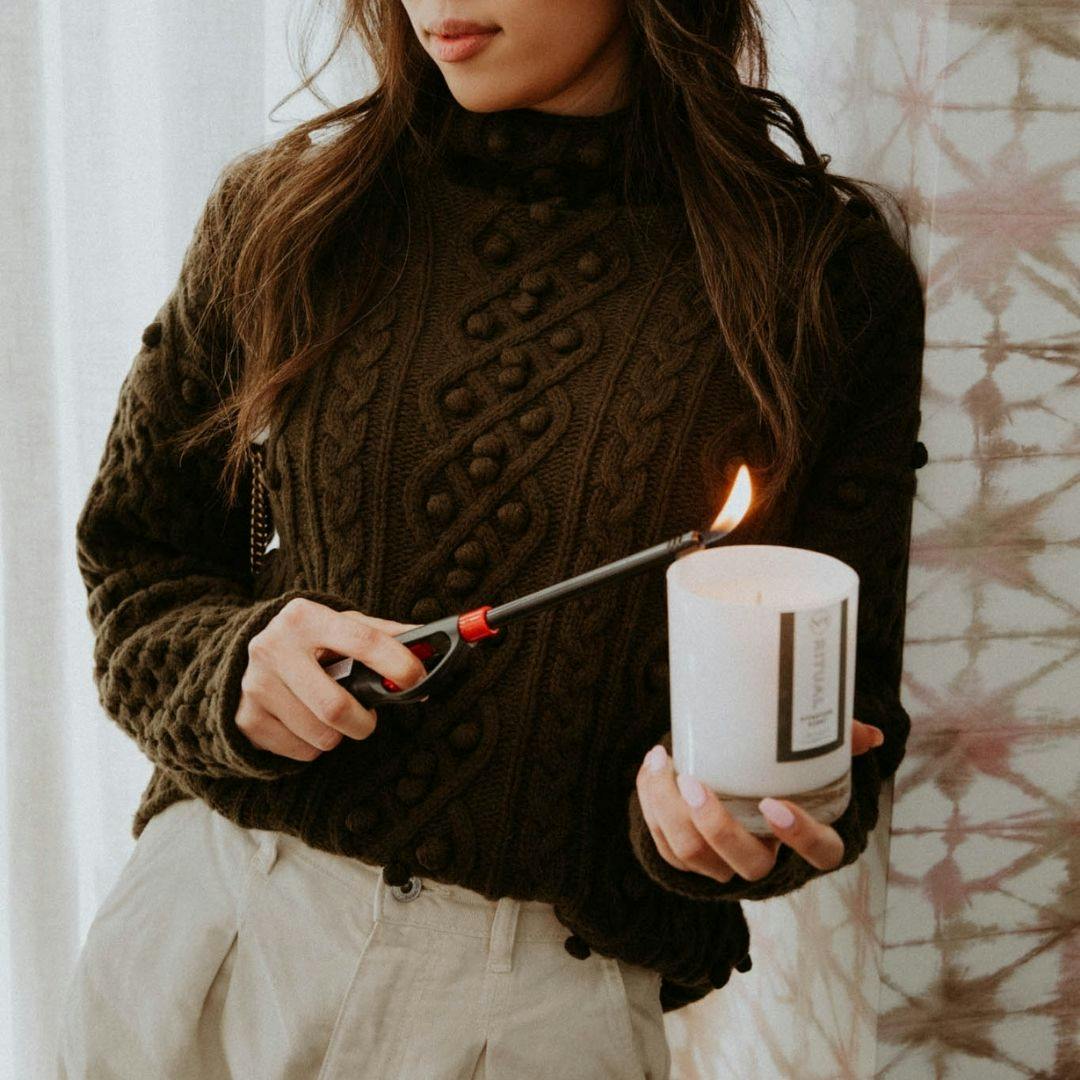 someone lighting a candle