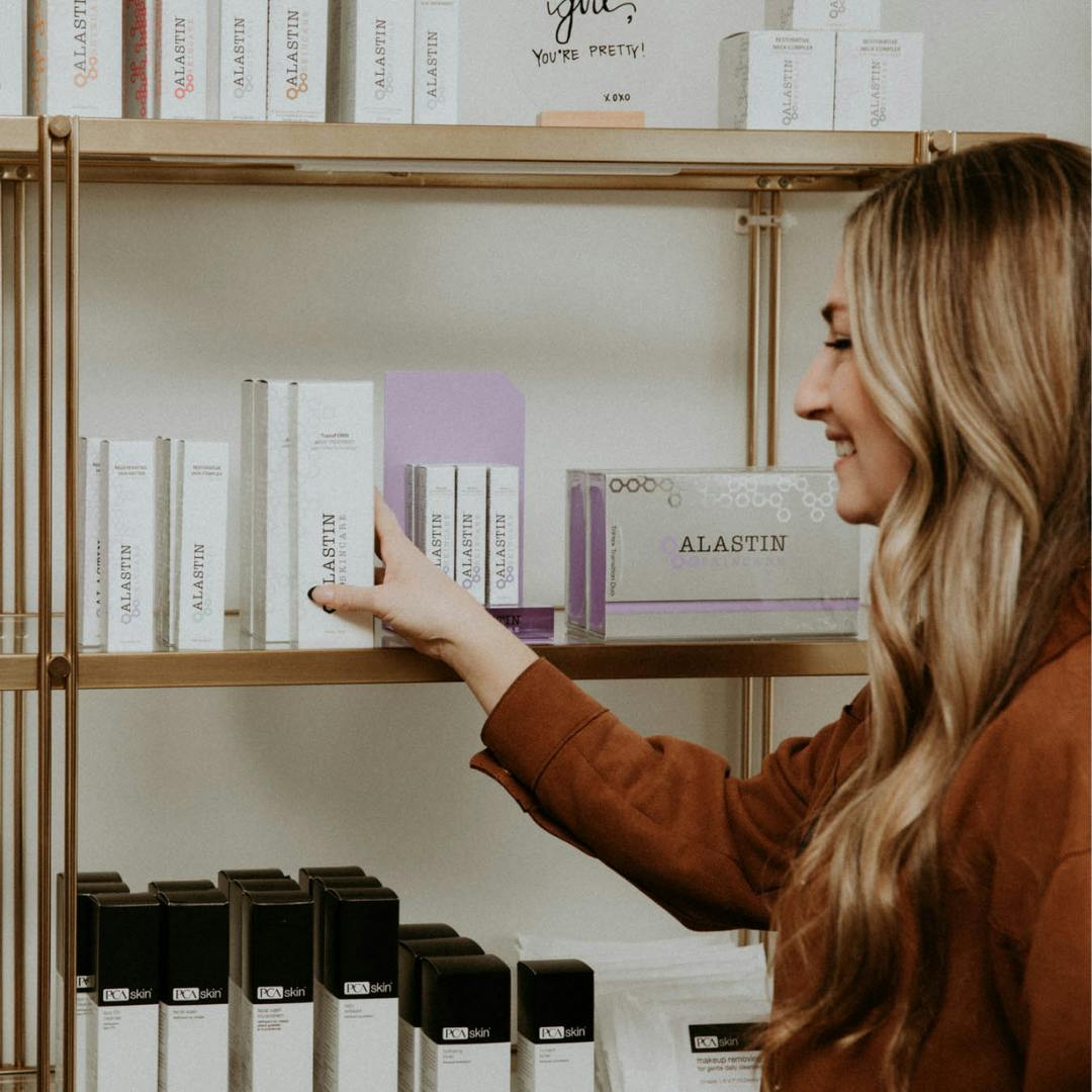 woman grabbing skincare products