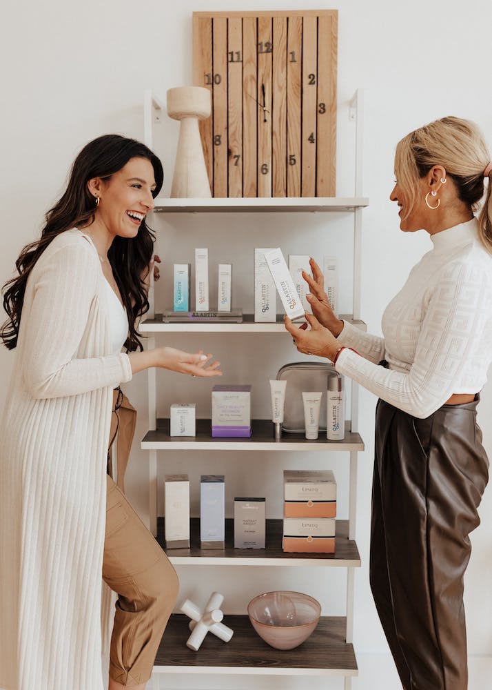 two women discussing skincare products