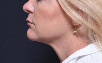 a close up of a woman with a nose ring and a nose ring