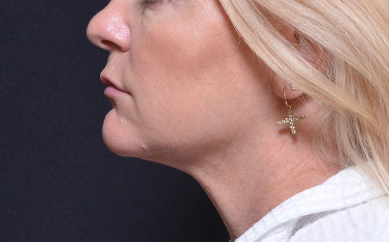 a close up of a woman with a nose ring and a nose ring