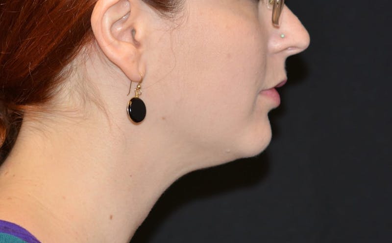 there is a woman with red hair and earrings on her face