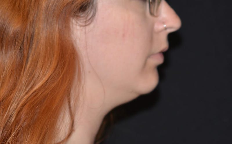 there is a woman with red hair and glasses looking at something
