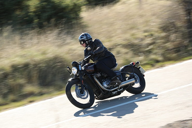 Open face lid, jacket, jeans and boots. Standard attire for a Bobber