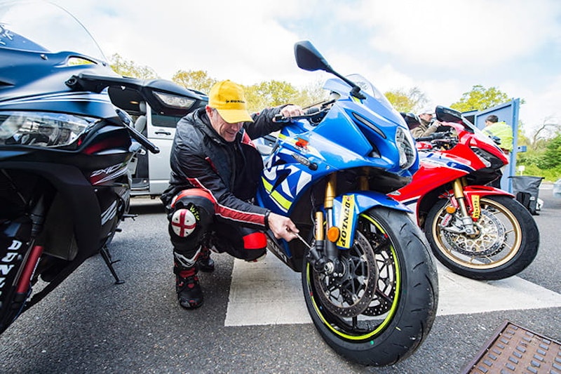 Kane Dalton checks the tyre pressures on the Suzuki GSXR1000
