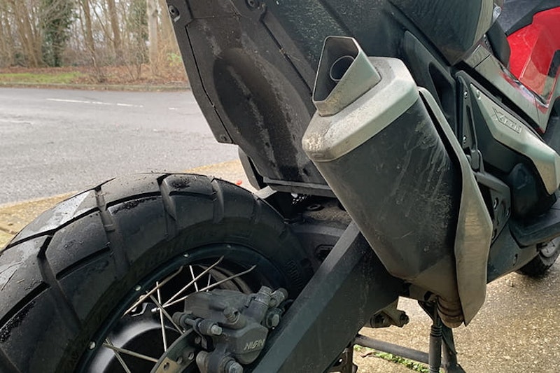 Honda’s 750cc, 75mpg adventure commuter scooter continues to defy convention. But we love it all the same