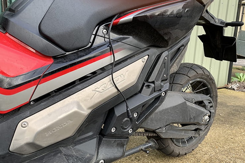 Honda’s 750cc, 75mpg adventure commuter scooter continues to defy convention. But we love it all the same
