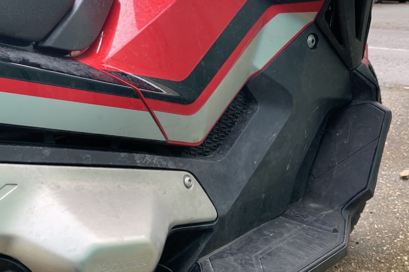 Honda’s 750cc, 75mpg adventure commuter scooter continues to defy convention. But we love it all the same