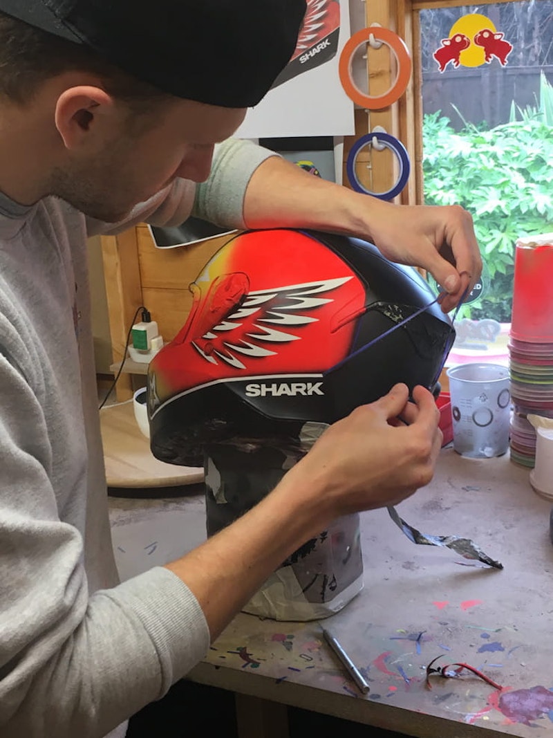 DrKolor peels back the masking tape after painting