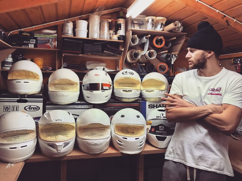 DrKolor stands next to some unpainted helmets.