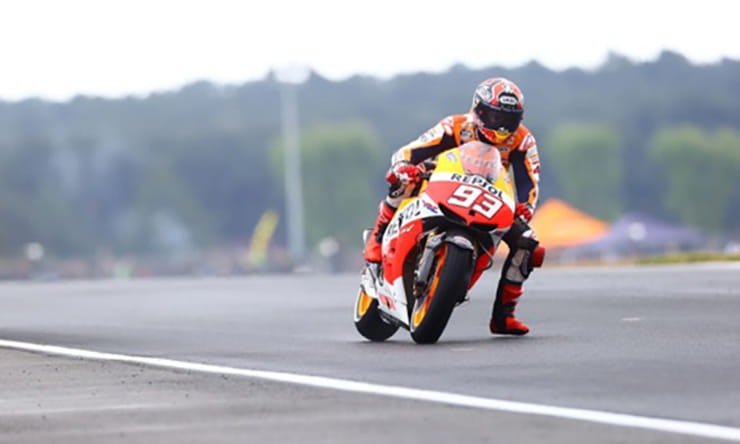 Why do MotoGP riders dangle a leg