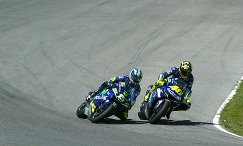 Why do MotoGP riders dangle a leg