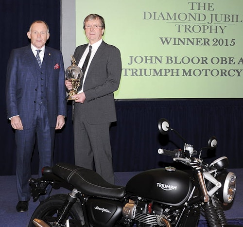 Triumph boss comes out of shadows to accept prestigious award