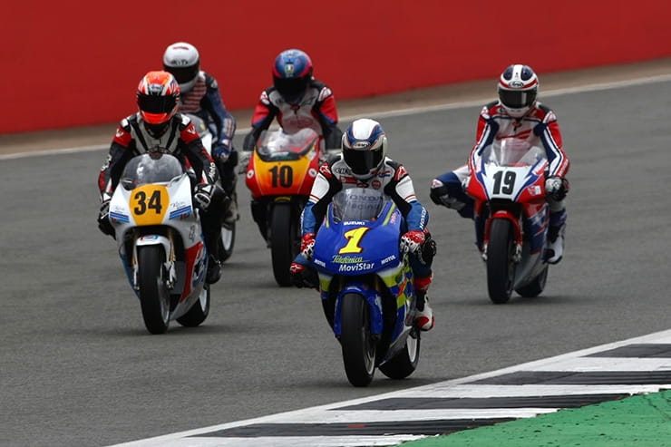 Classic MotoGP bikes racing around a track