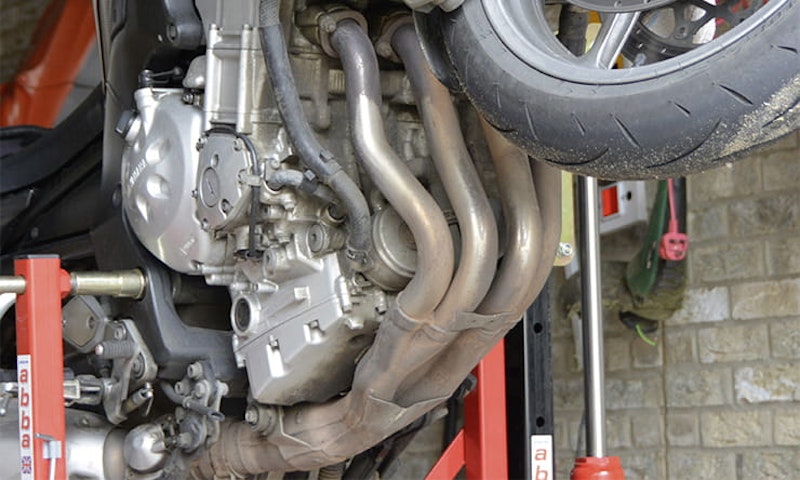 Your bikes downpipes are perfectly placed to get a faceful of whatever the front wheel flicks at them – spray, salt, grit. Here