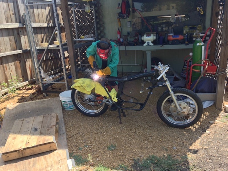 Zeke gets the welding iron onto the Honda frame