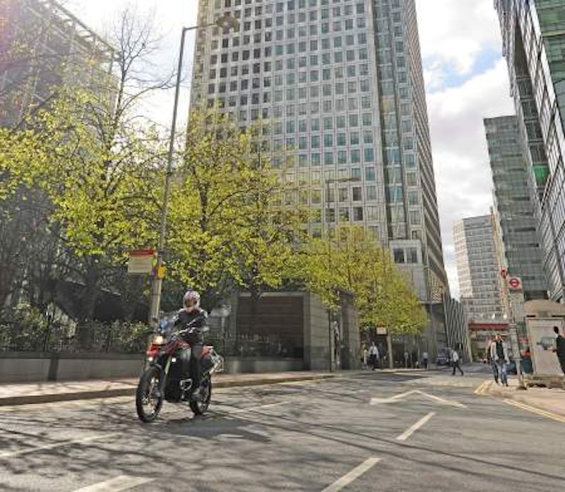 A small bike in a large city