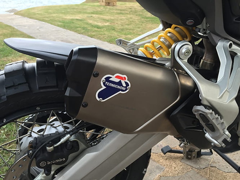 Higher, tucked away out of harm's reach and no doubt loud too. We love the Multi's aftermarket pipe.