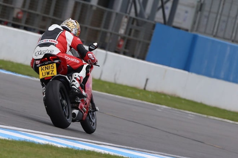 Wheelie control dialled in to level four and the bike barely lifts on to the start-finish straight.