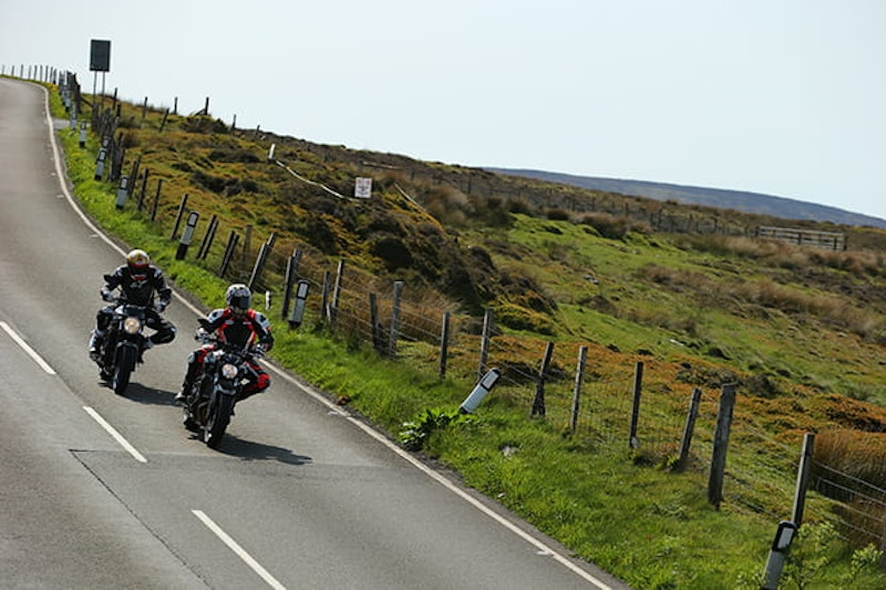 Suzuki and Yamaha heading to Guthries Memorial the wrong way around the TT course
