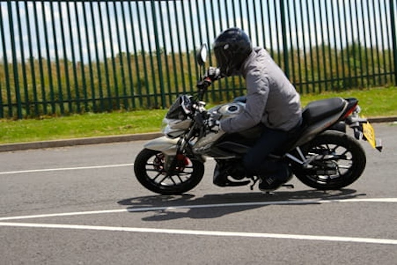 Kymco's 125cc CK1 almost having its pegs 'bedded in'
