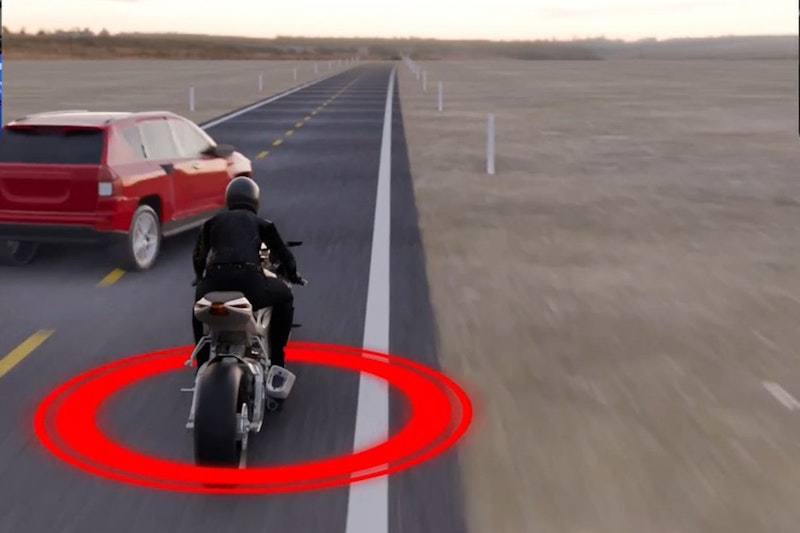 A car swerves while being overtaken by a motorcycle