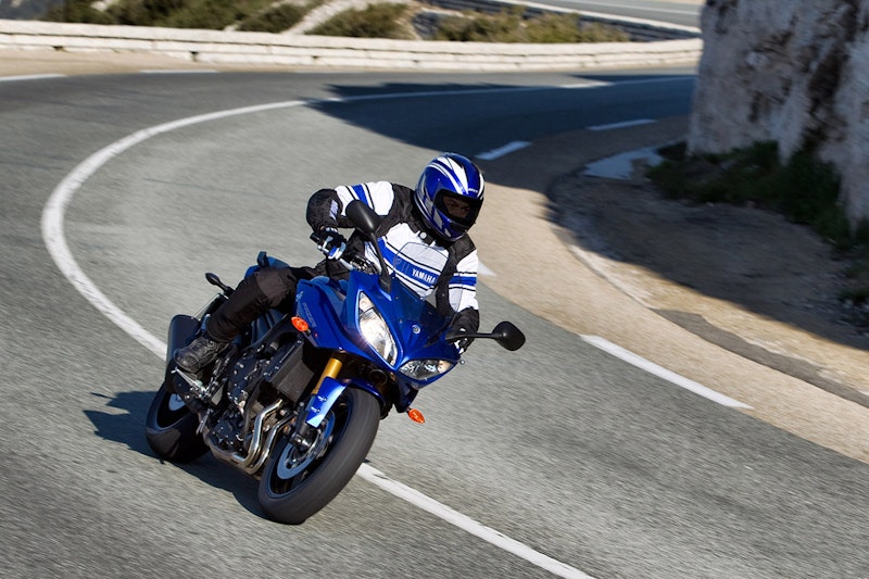 2010 Yamaha FZ8 Fazer purple blue front view on winding mountain road left hand bend