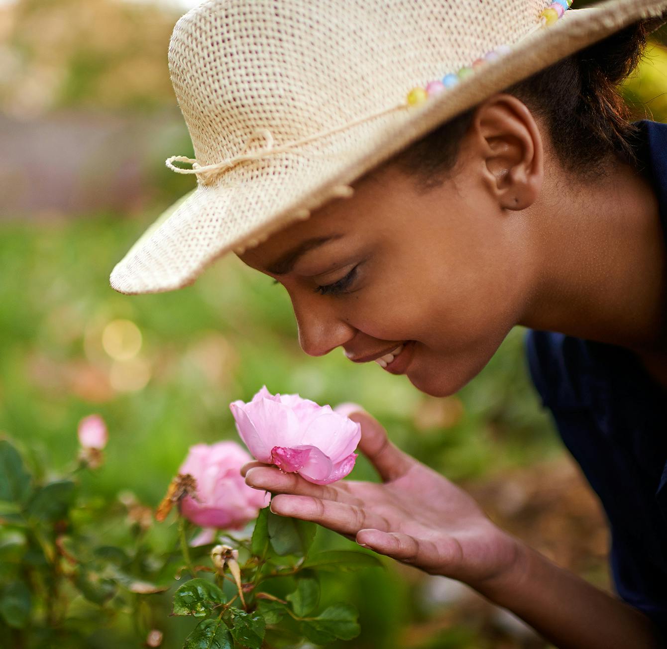 woman smelling a pink flower