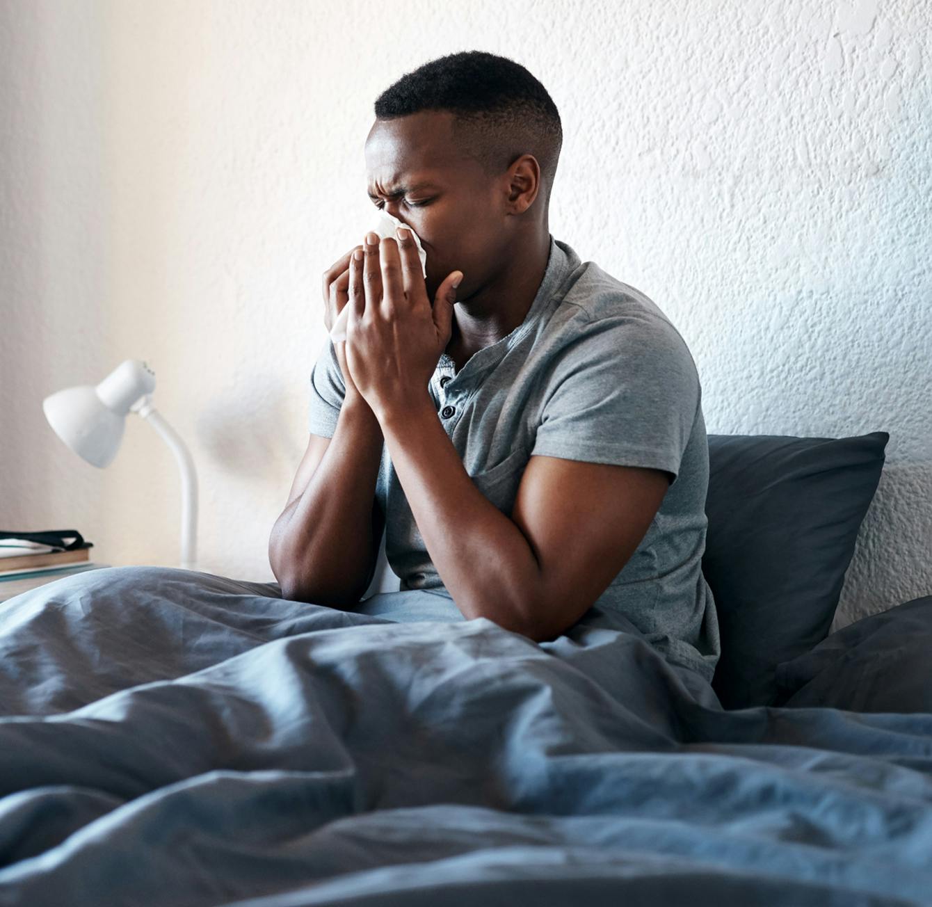 man blowing his nose