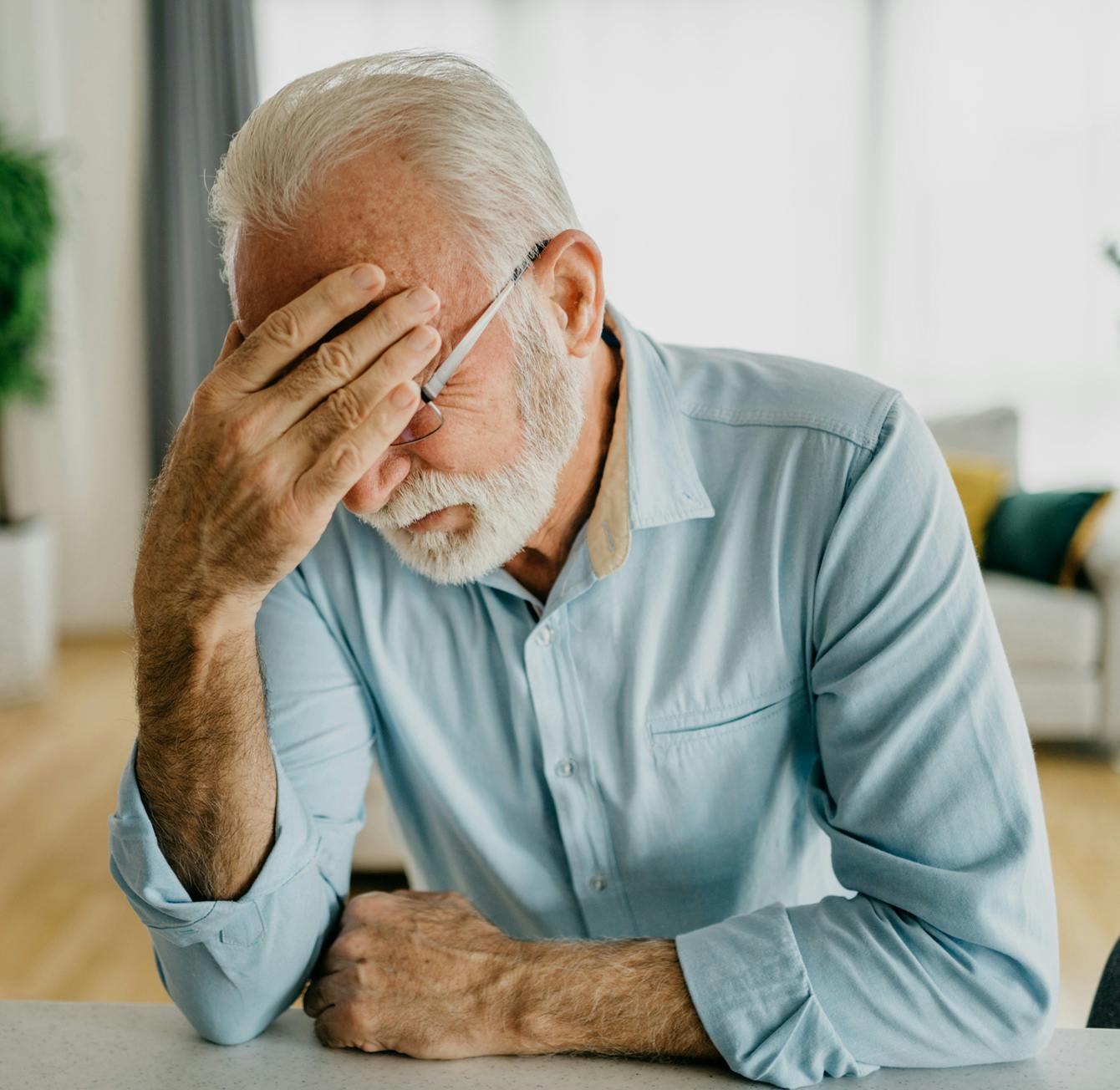 man holding his head in discomfort