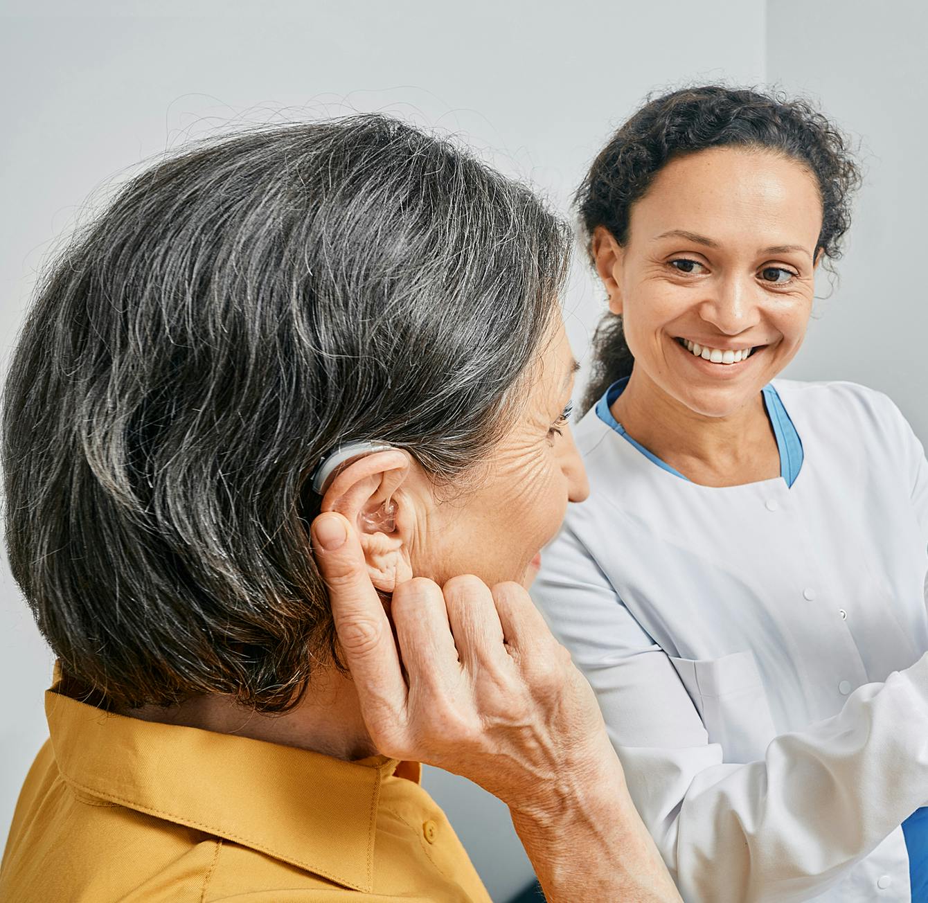 woman trying on hearing aids