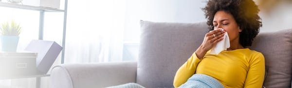 woman blowing her nose