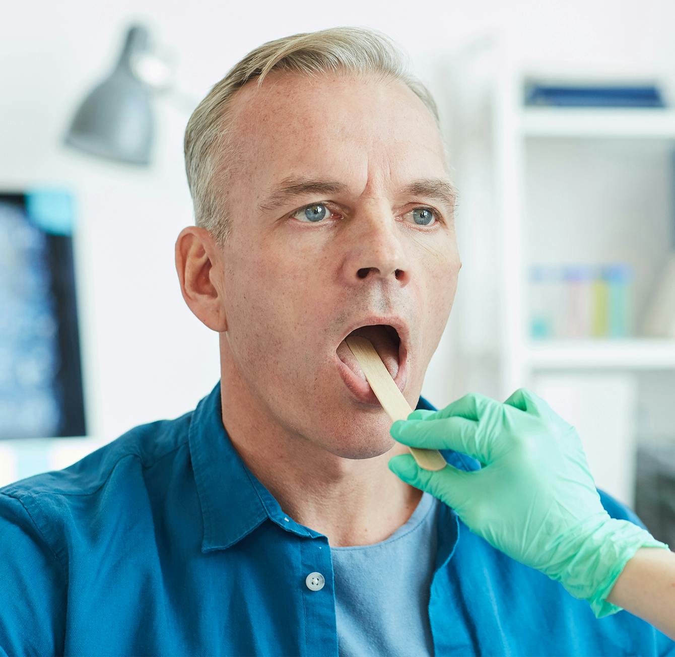 man having throat examined