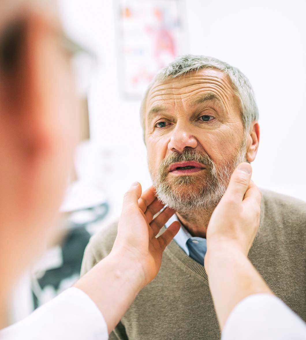 doctor evaluating a man's neck