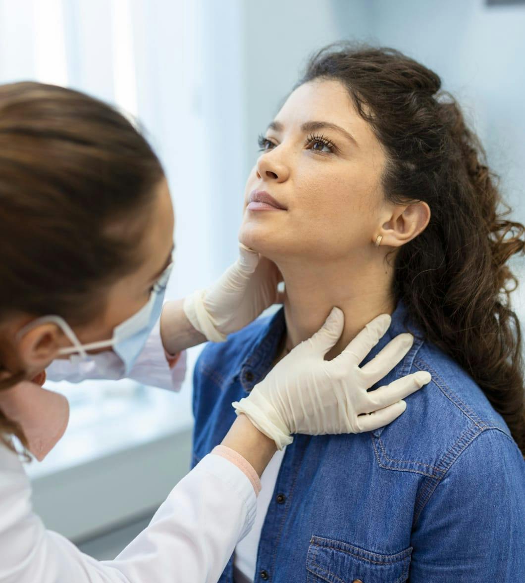 woman's neck being examined