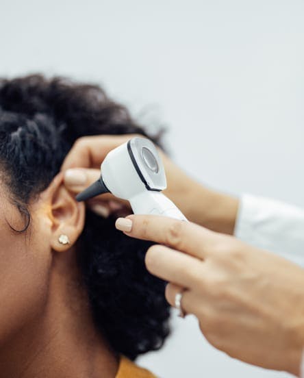 doctor looking in patient's ear