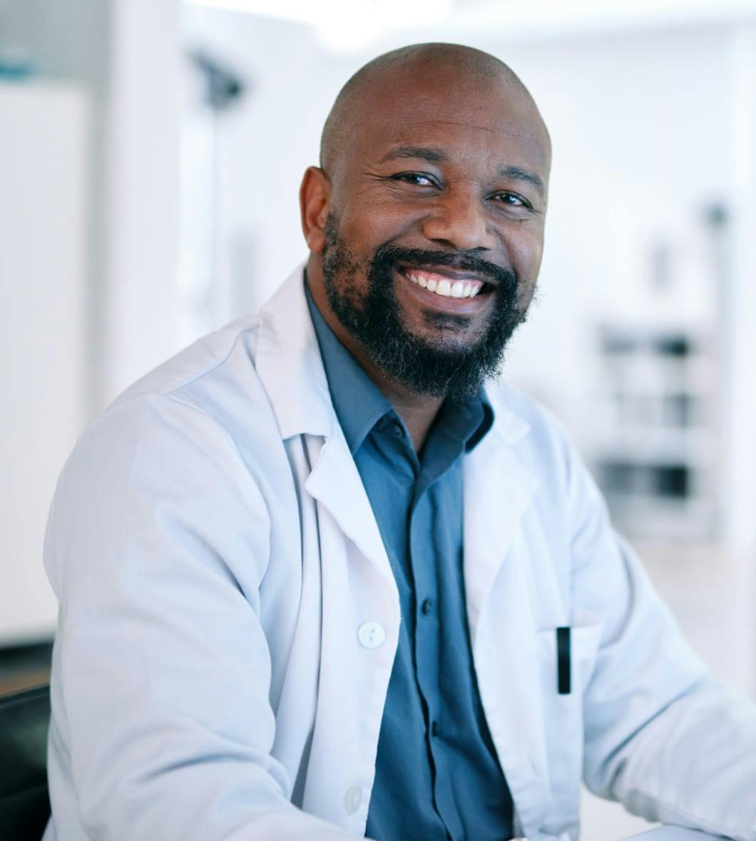 man in white lab coat smiling