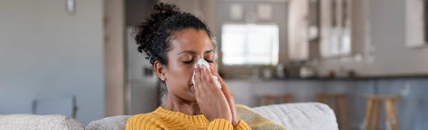 woman blowing her nose