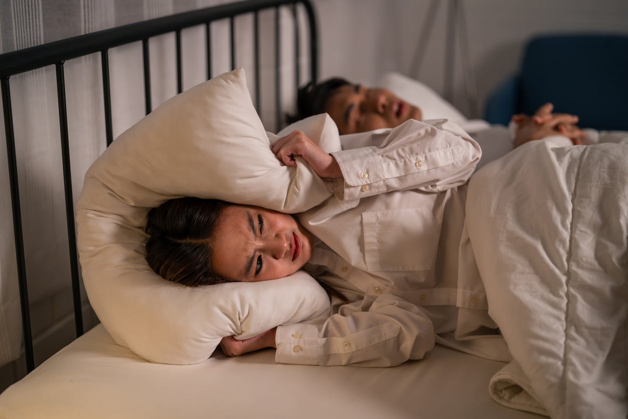 woman annoyed with husband's snoring