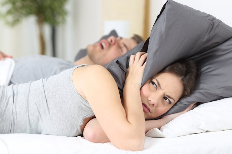 woman annoyed by husband snoring