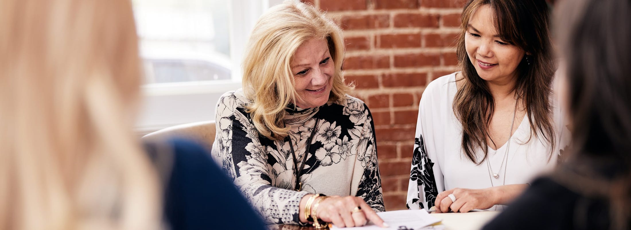 Attorneys Mary Wilson and LoAn Kim Vo looking at a paper