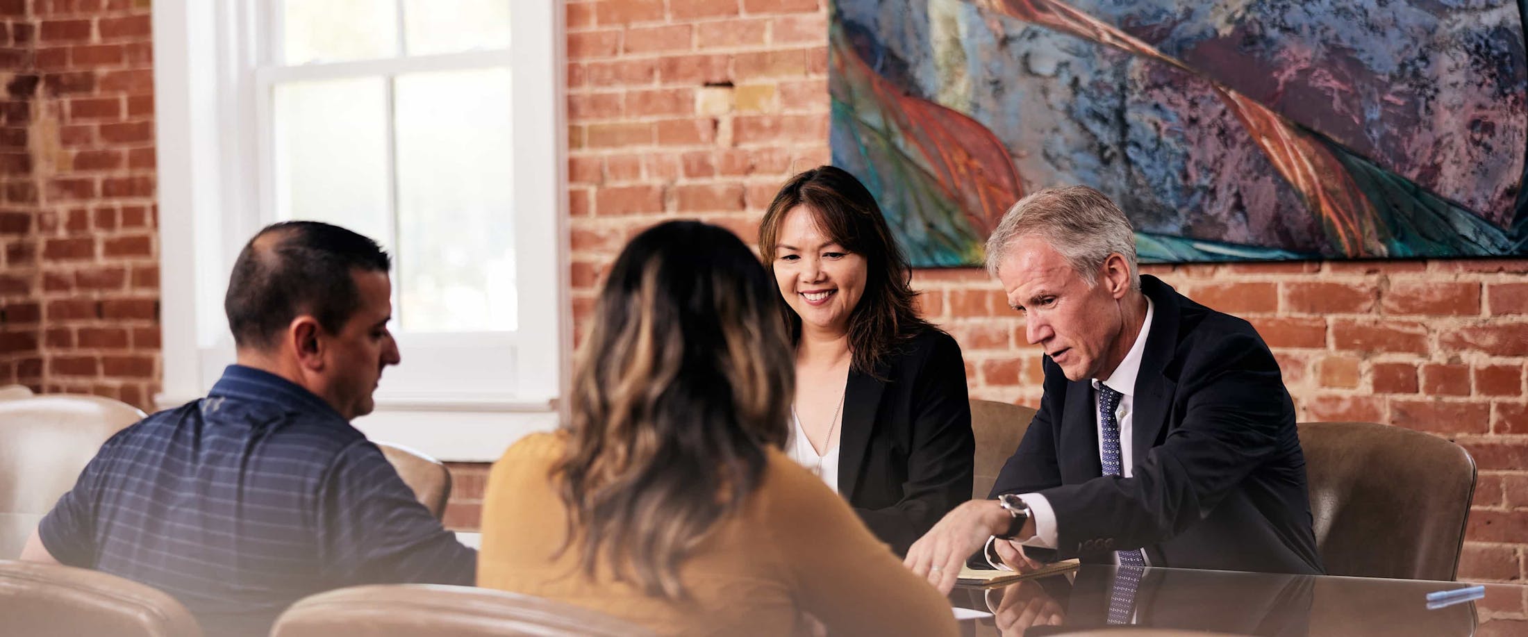 LoAn Kim Vo and Sean Michael Lyons talking to clients